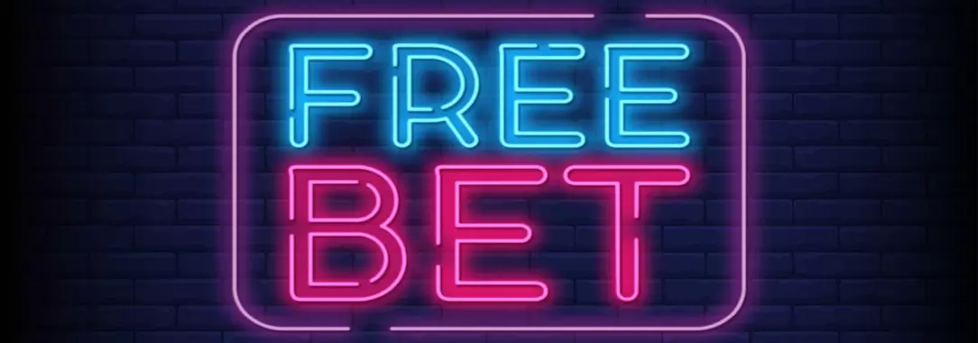 An illustration of a bright pink and blue neon sign of ‘free bets’ on a dark brick wall