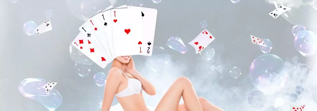 Photo collage of a woman in a bikini with her head concealed by cards surrounded by floating bubbles, playing cards