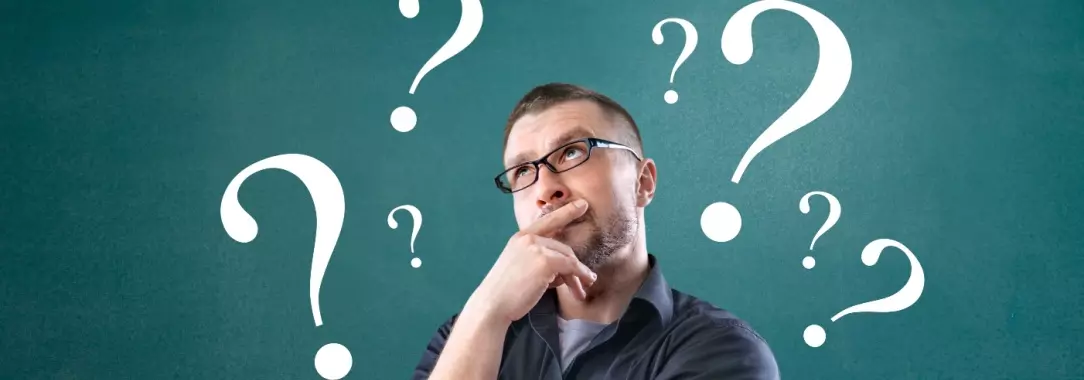 A photo of a man deep in thought isolated on a teal background with white question marks